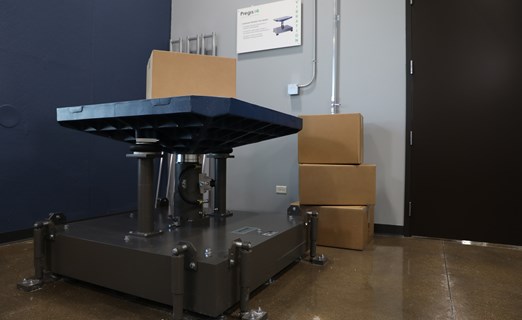 Machine lifter is lifting boxes inside the Pregis IQ