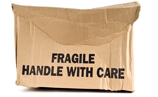 Damaged fragile brown cardboard box