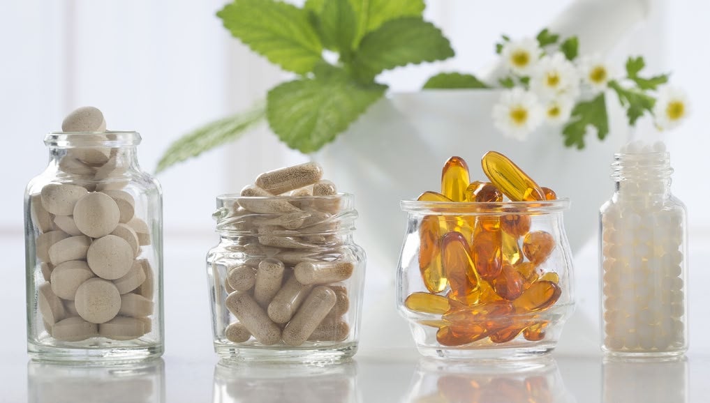 pills and capsules inside glass containers