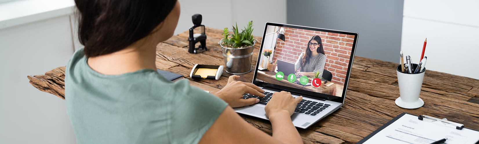 two people communicating on a video call through laptop