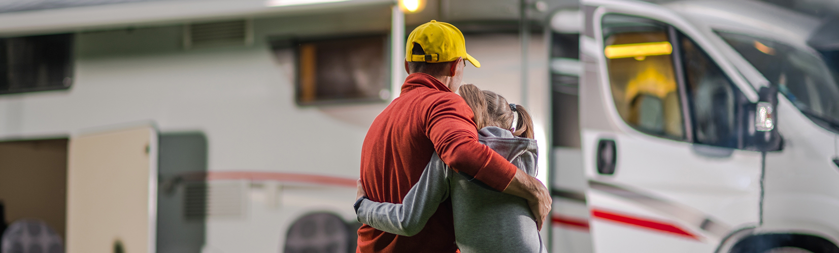 couple looking at white RV