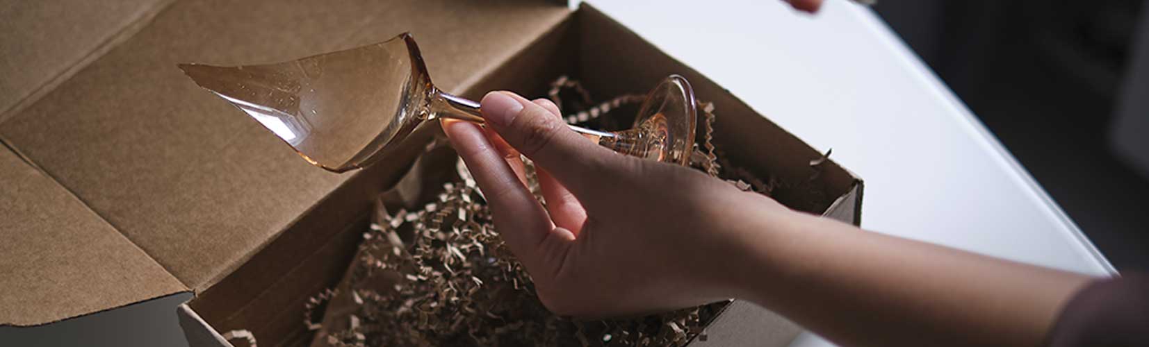 damaged wine glass inside fragile box packaging