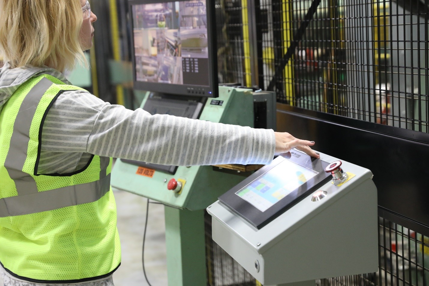 woman working on packaging machinery