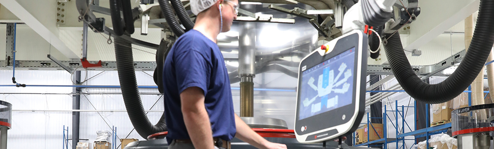 A person uses a machine system inside a warehouse.