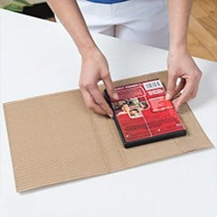 A product is placed in the center of cohesive mailer box.