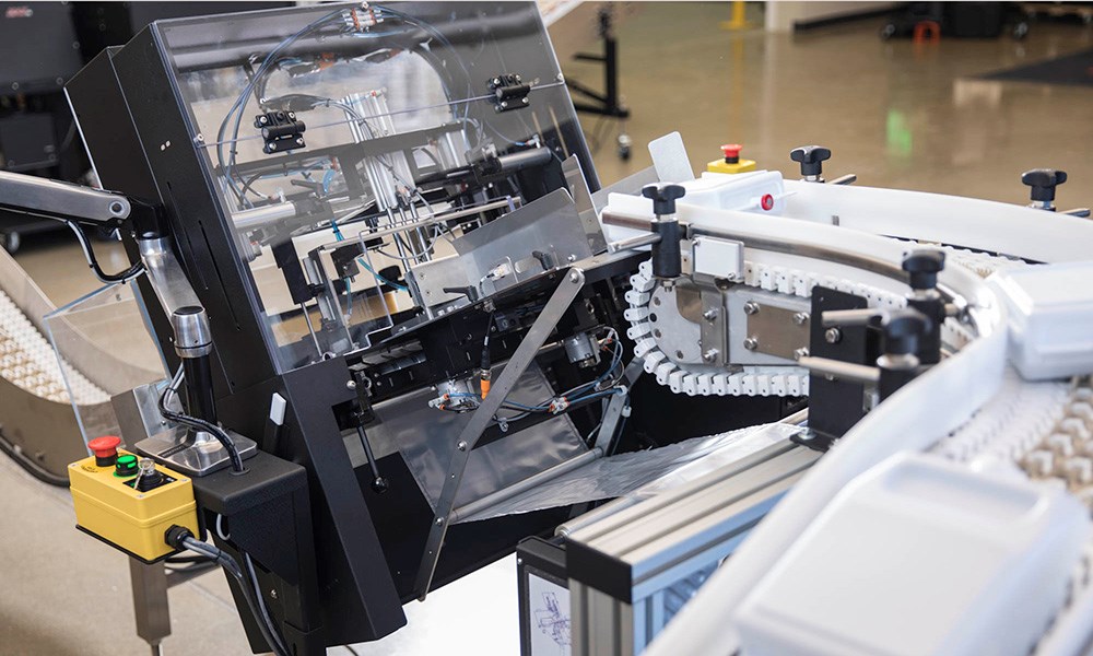 A custom integrated poly bag solution using conveyor belts.