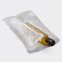 Image of a bottle wrapped securely in a clear Pregis bubble bag, providing cushioning and protection during transportation or storage.