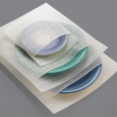 Ceramic plates inside foam bags are stacked together.