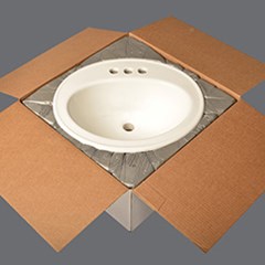 Foam in place used to block & brace a sink inside a cardboard box.