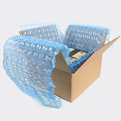 Blue tinted HC Inspyre protective cushioning inside a cardboard box.