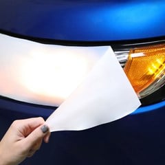 Polymask protective film coverings for headlights, used during transport of the vehicle.