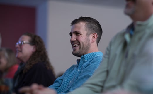 Professional responding positively in blue attire during meeting